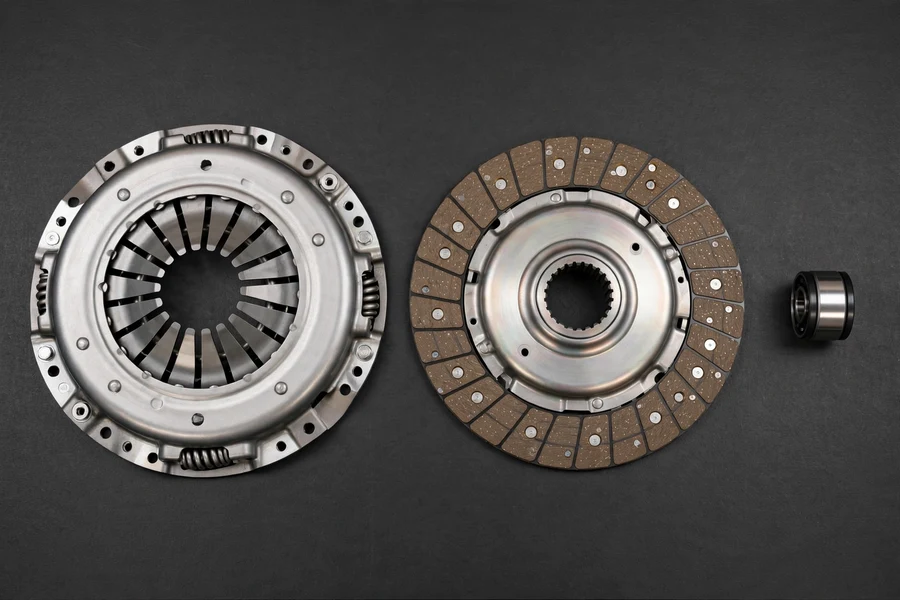 BMW 3 Series clutch kit components: pressure plate, clutch disc, and throwout bearing laid out on a workbench
