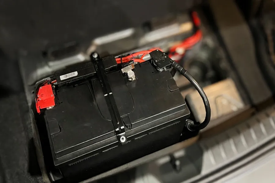 BMW 12V battery installed in the trunk battery compartment