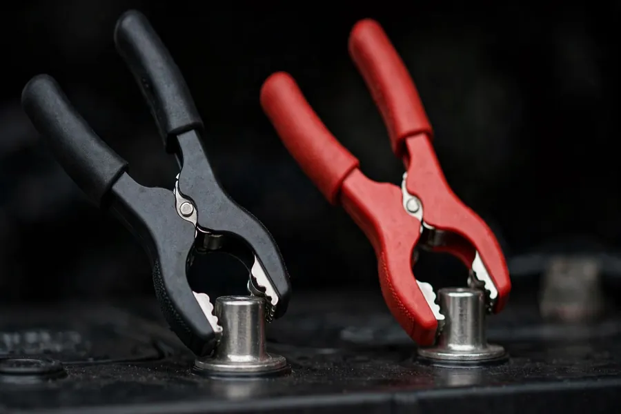 Close-up of car battery terminals with cables connected