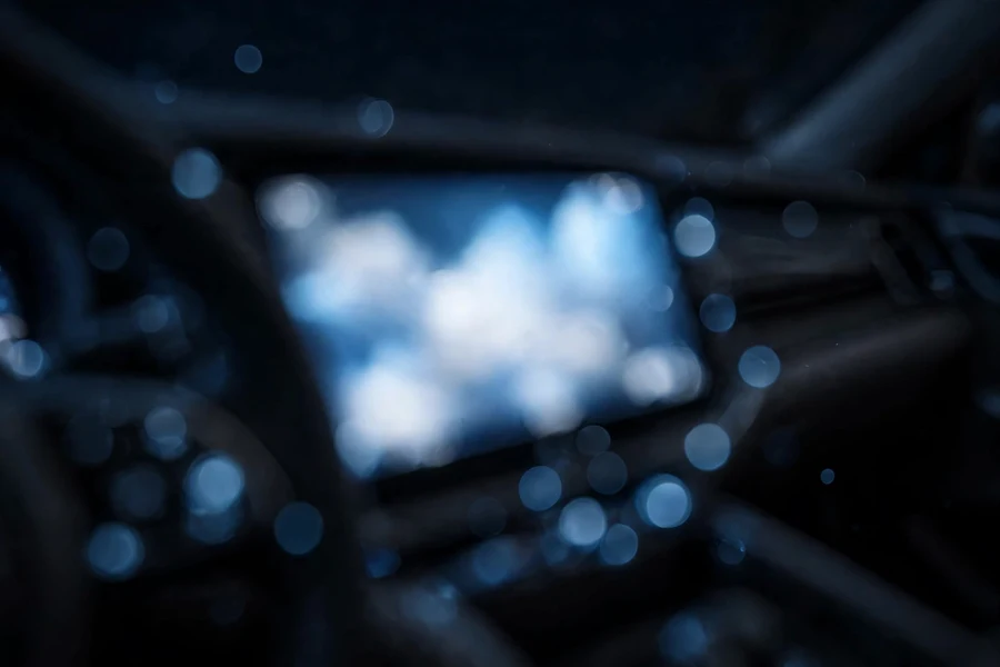 BMW iDrive display glowing in a dark cabin during a tire pressure monitor reset