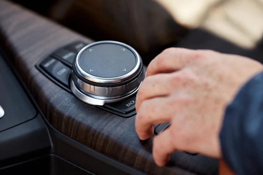 Close-up of a BMW iDrive central display showing vehicle status, the screen used to check engine oil level electronically