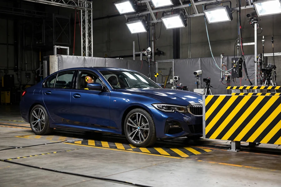 Car in a crash test facility with a crash test dummy visible inside
