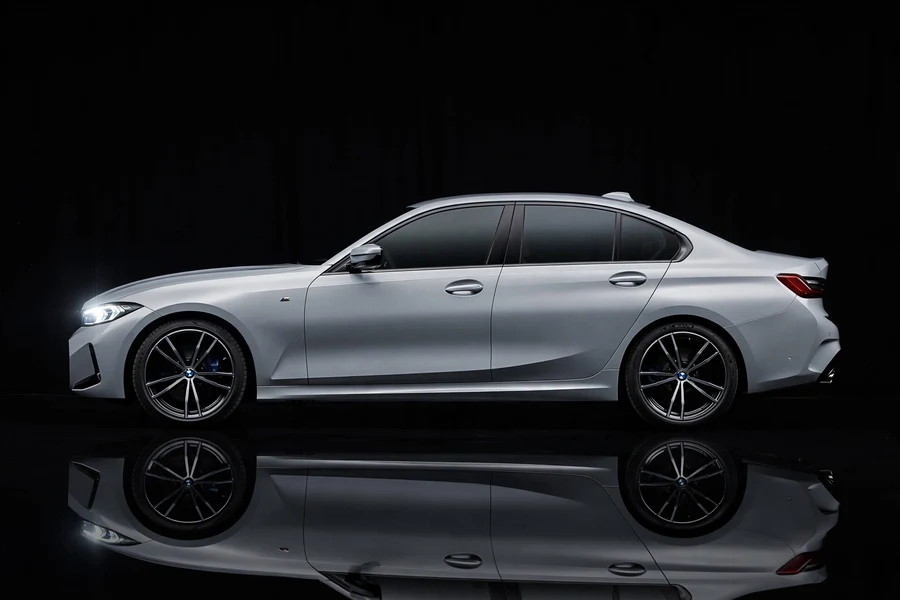 Silver BMW 3 Series sedan side profile in a studio