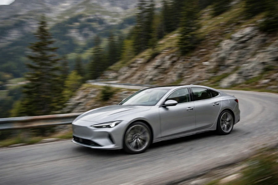 Silver sport sedan cornering on a mountain road, no badges visible