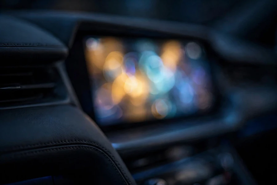 Car dashboard and infotainment display glowing at night, shown blurred