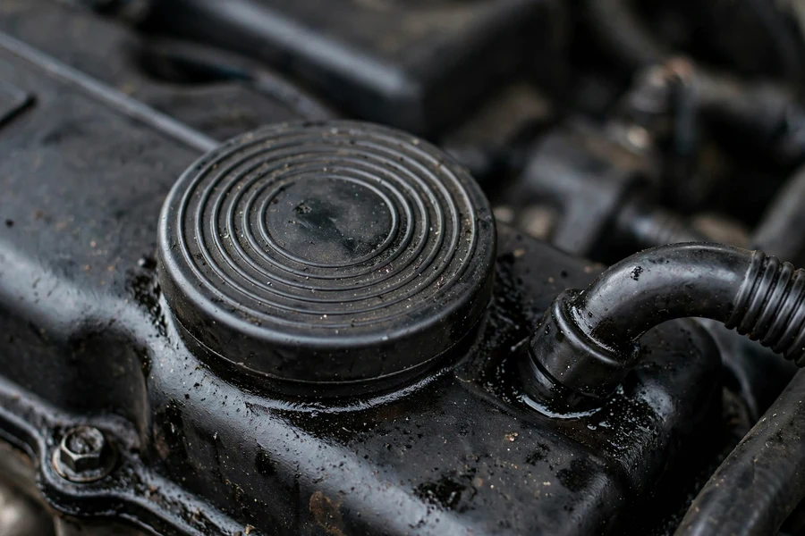 Close-up of the round crankcase vent valve diaphragm cap on a BMW valve cover