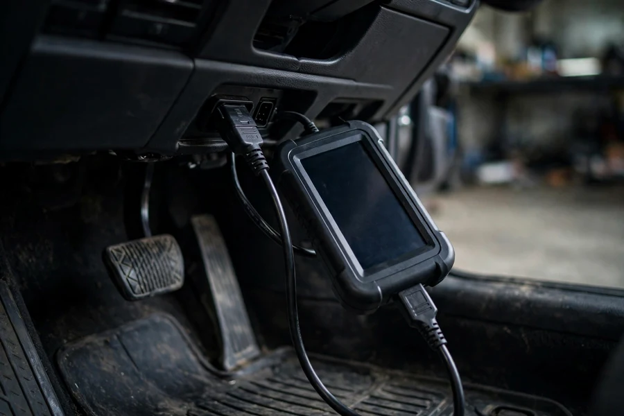 Diagnostic scan tool connected to a BMW OBD-II port for DSC service functions