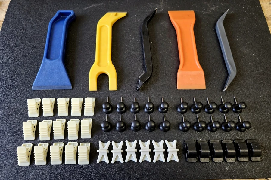 Plastic trim removal tools and trim clips on a workbench
