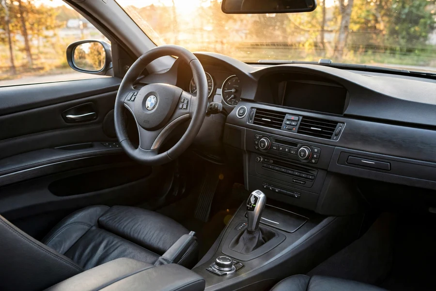 BMW E90 328i driver cockpit with black leather interior