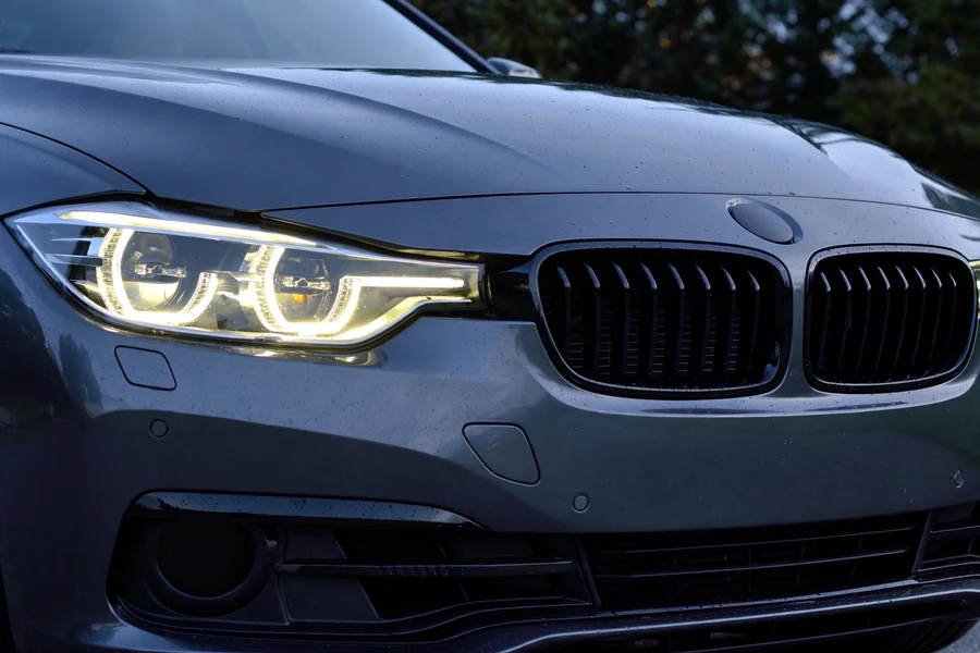 Facelifted BMW F30 3 Series front with LED headlights at dusk